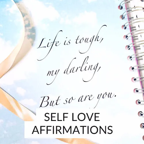 Self love affirmations | Image shows a self-love affirmation on the page of a journal, with a peach ribbon laying across it.