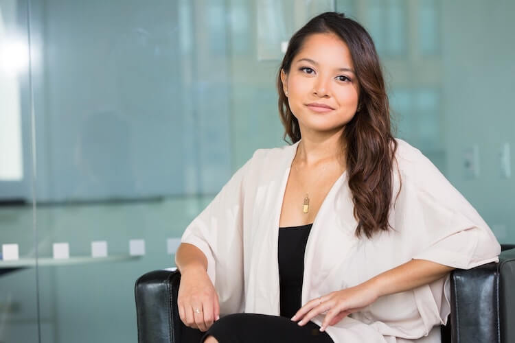 A corporate headshot of a woman with an open neckline.