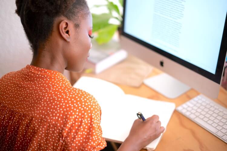 Lifestyle shot of woman working at her desk.