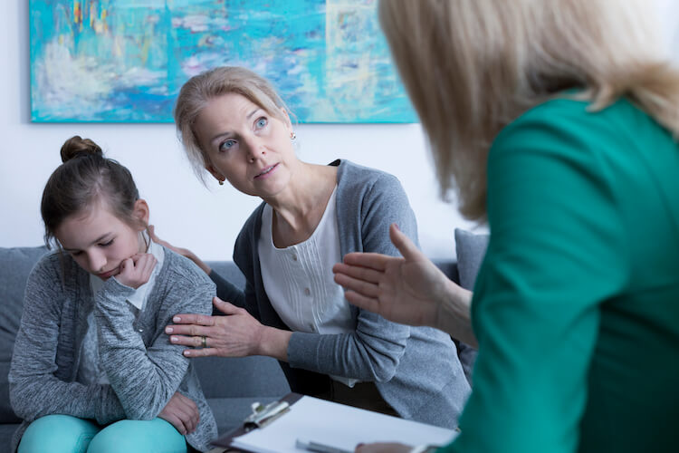 Overprotective mother speaks to a therapist about her daughter. This is what enmeshed parenting can look like.