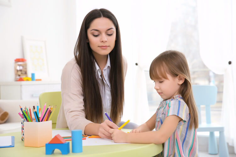 Play therapist colouring with a child.