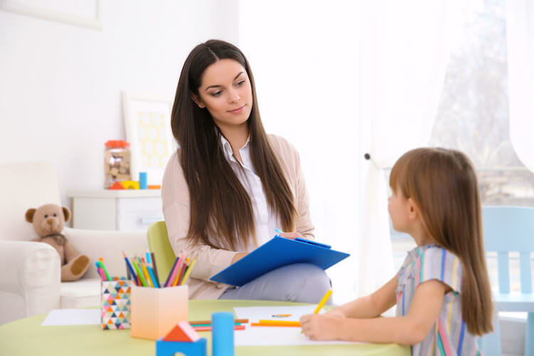 Therapist talking to a child.